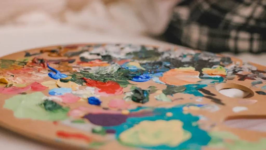 A photo of a painter's palette mixed with various colors. Illustrates [alt text].