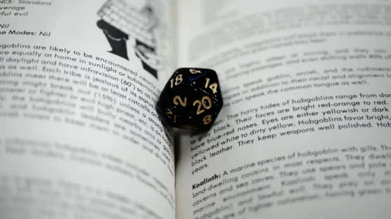 dnd-book-dice A photo of a Dungeons & Dragons die on top of book pages.