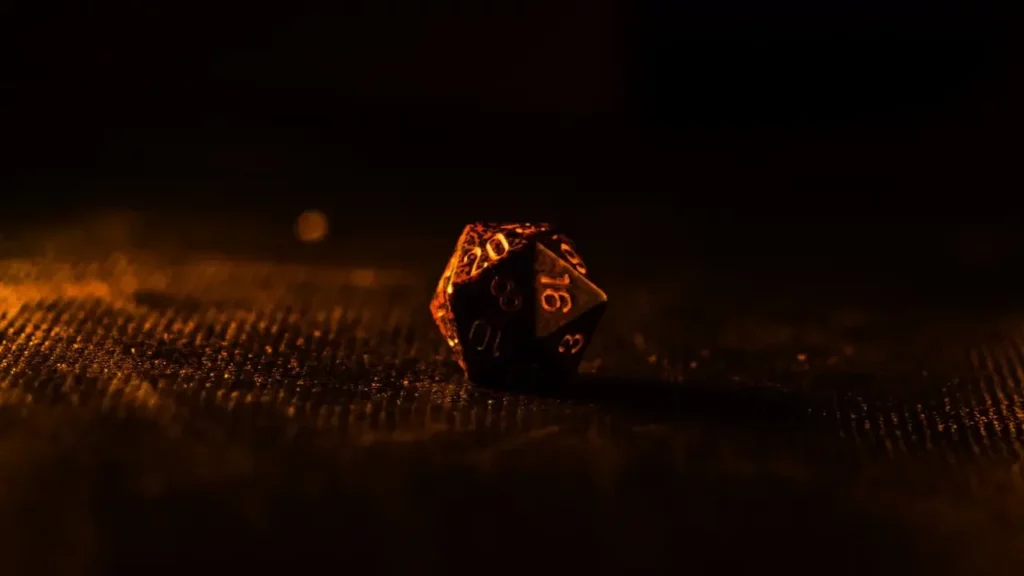 A close up of a D20 dice on a table.