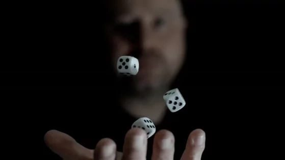 a-man-is-throwing-dices-into-the-air A man is throwing dices into the air.
