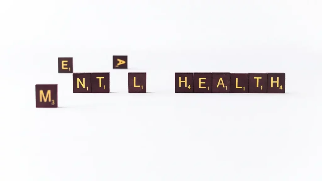 A set of wooden blocks spelling the word mental health words in scrabble letters.