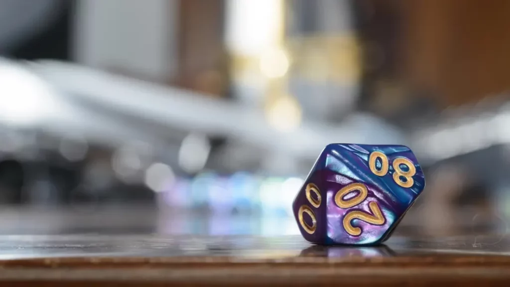 A small purple and blue dice.