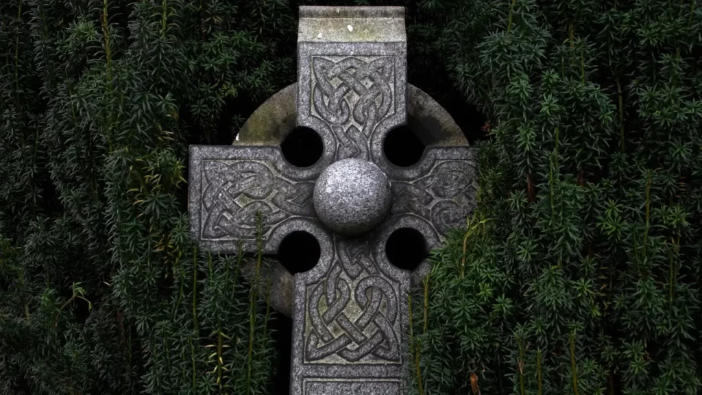 Gray concrete cross statue.