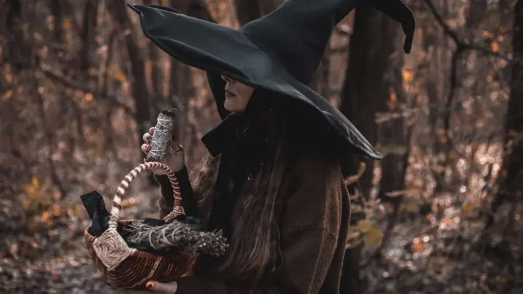 Photo of a woman dressed as a witch in an autumn forest. Themes of 2024 Player's Handbook.