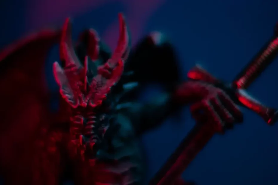 A close up photograph of a dragon miniature holding a sword. Themes of 2024 Dungeon Master's Guide.