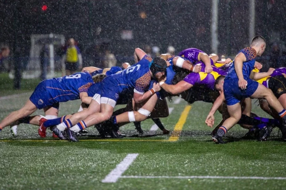 A game of rugby during a scrum in the rain.