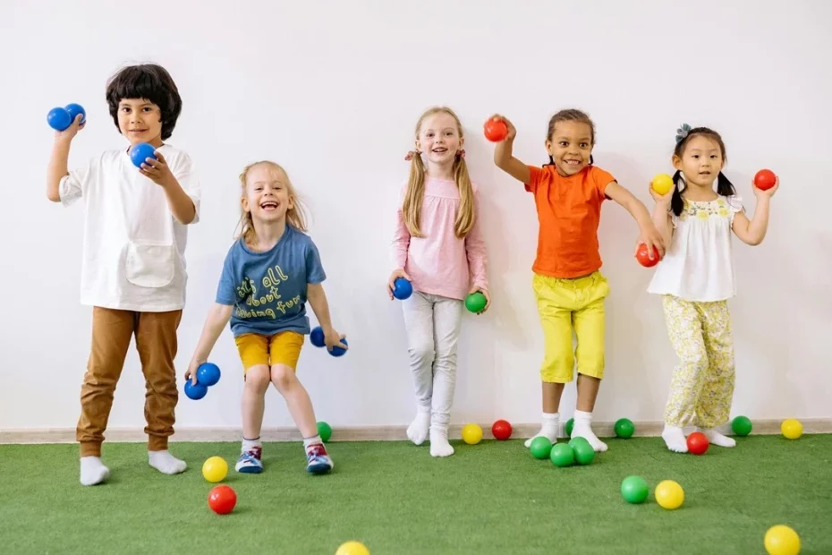 Five children against a wall throwing toys