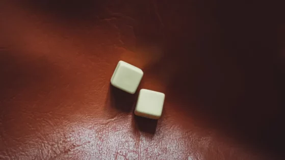 white-square-on-red-leather White empty dices on red leather.