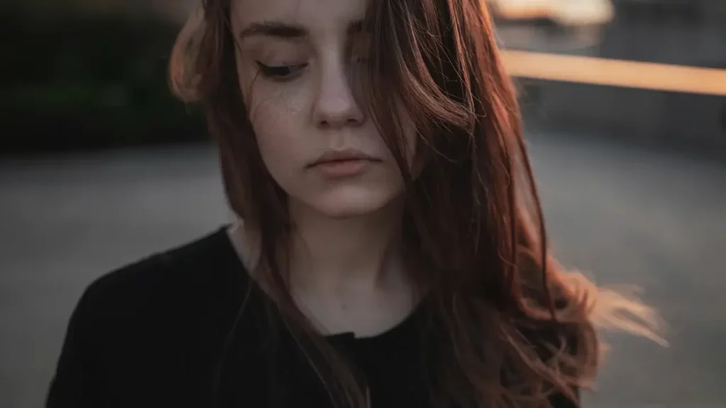 Woman in black shirt. Themes of social anxiety.