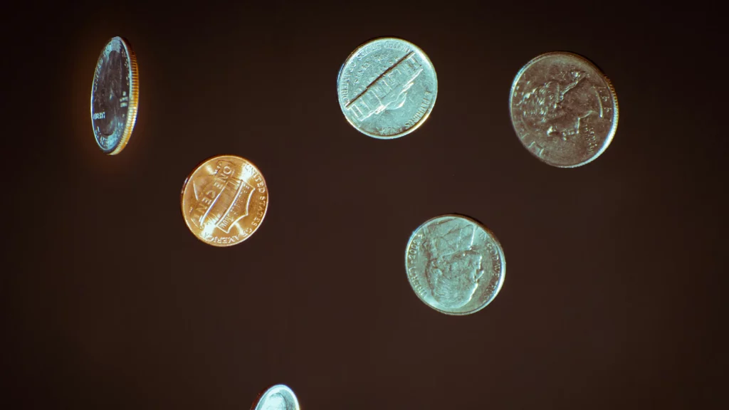 Photo of 71 cents in free fall with a black background.