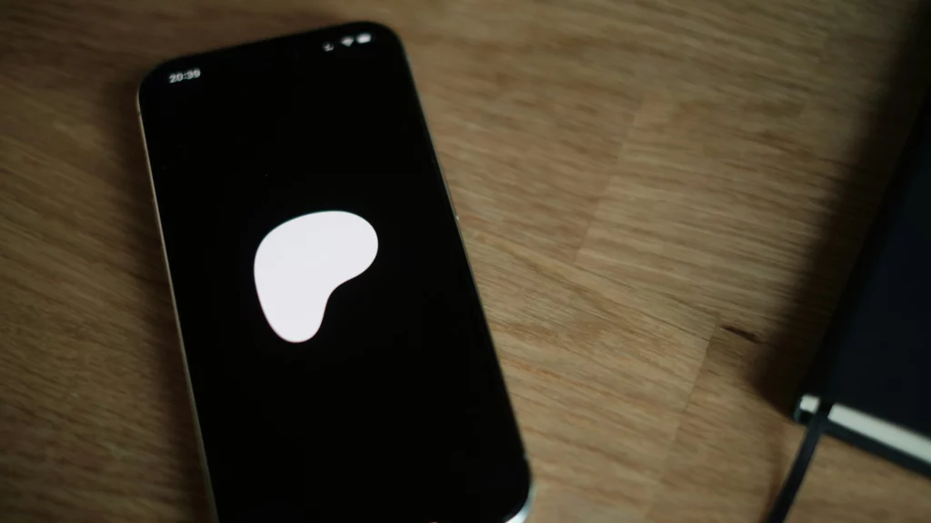 A cell phone with the Patreon logo in its screen. Themes of Patreon content creation.