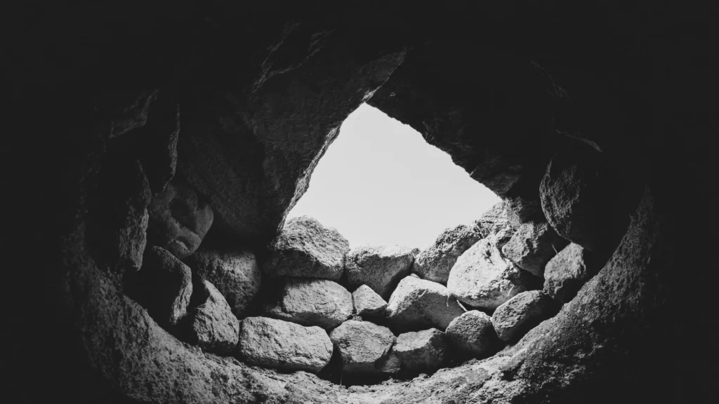 A black and white photo of rocks in a cave