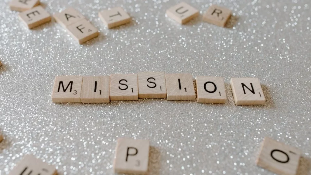 A photo of a silver tray with scrabble letters on it spelling out the word "MISSION."