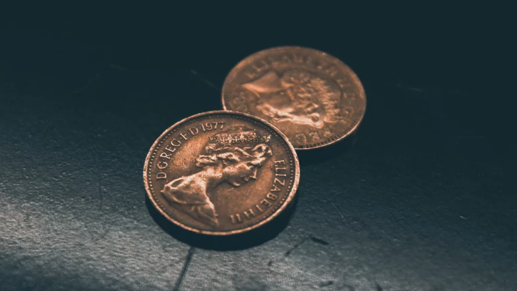 Two round gold colored coins. Themes of accidents and theft.
